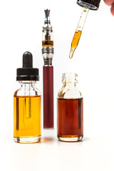Assorted flavors vape juice and eyedropper being used isolated on white background