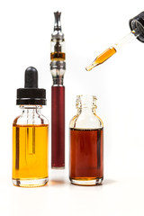 Assorted flavors vape juice and eyedropper being used isolated on white background