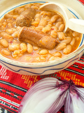 traditional cuisine beans with sausage and red onion