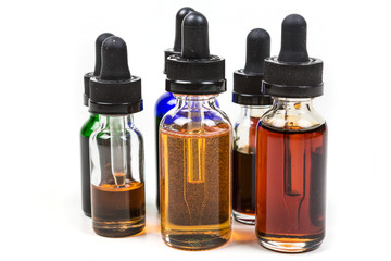 Assorted flavors of vape juice isolated on white background