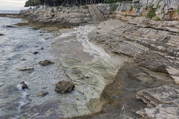 Sunset rocky beach in Istria, Croatia. Adriatic Sea, Lanterna peninsula.
