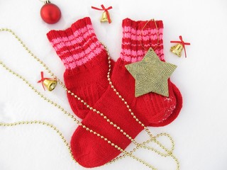 
Christmas, New Year's background with warm socks, bells, stars, beads on a snow