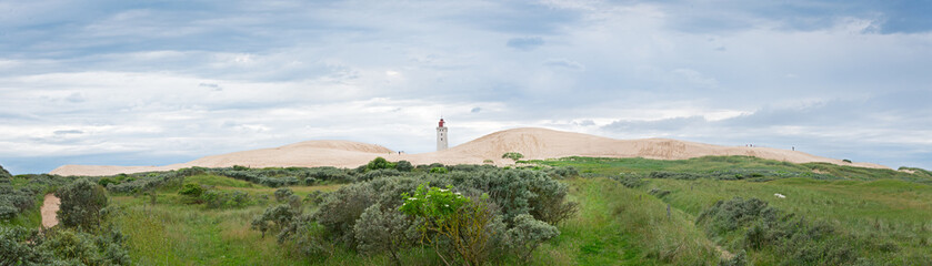 Panorama of the sandy dunes with the abandoned lighthouse of Rub