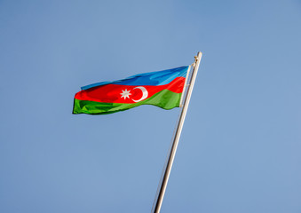 Azerbaijan flag fluttering on a metal flagpole 