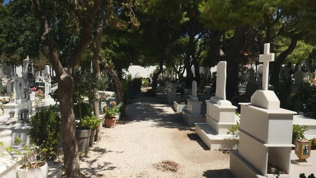 Lovely, well kept, sunny cemetery with trees in Greece.