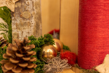 Christmas decoration with red candle and golden bauble