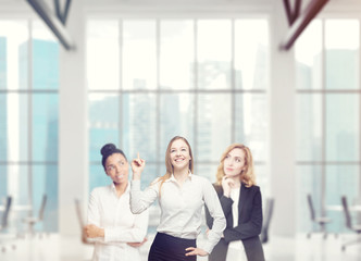 Three women in an office brainstorming