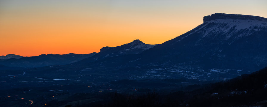 Panoramic winter sunset view of the mountains of Ceuse (also known as C&eacute;uze or C&eacute;use) and C&eacute;uzette (Petite C&eacute;uze). Hautes Alpes, Southen French Alps, France