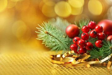 Composition of mistletoe, ribbon and coniferous branch on blurred background, close up