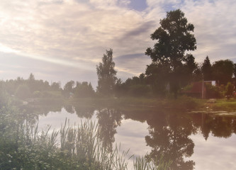 Misty summer pond, countryside landscape