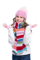 Smiling cute little girl wearing knitted sweater and colorful scarf, hat, mittens isolated on white background. Winter clothes.