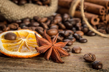 Obraz na płótnie Canvas Coffee beans, anise, dry orange and cinnamon sticks