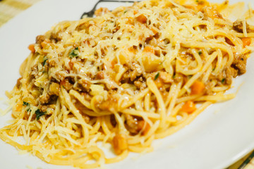 Pasta spaghetti bolognese with grated cheese on a plate