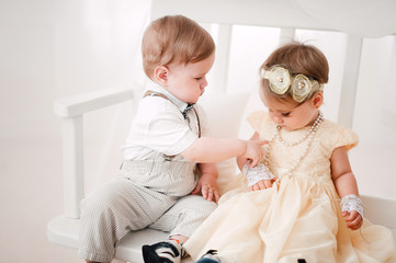 two babies wedding - boy and girl dressed as bride and groom