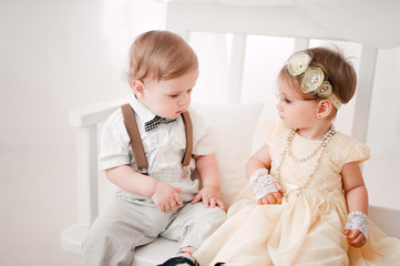two babies wedding - boy and girl dressed as bride and groom