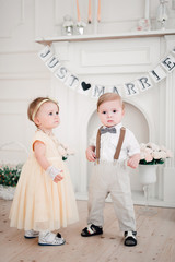 Fototapeta na wymiar two babies wedding - boy and girl dressed as bride and groom