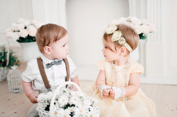 two babies wedding - boy and girl dressed as bride and groom