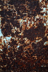 Background of rusted metal and torn paper left behind on a billboard