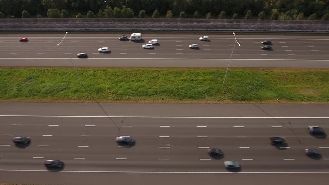 Traffic on 10-lane highway, aerial perspective.