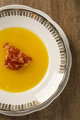 Pumpkin Soup with proschiuto on table