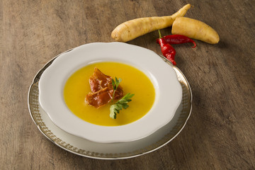 Pumpkin Soup with proschiuto on table