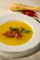 Pumpkin Soup with proschiuto on table