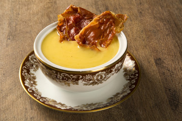 Pumpkin Soup with proschiuto on table