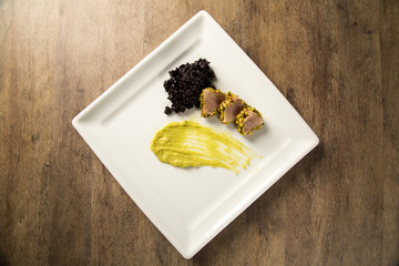 Tuna with pistachio crust, black rice and avocado puree