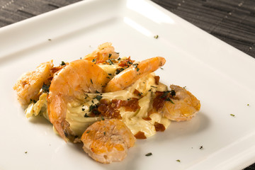 Pasta with shrimps served thyme and cheese