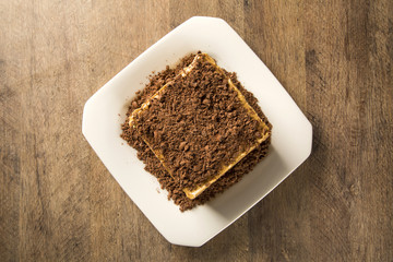 close up of a chocolate cream cake on white plate