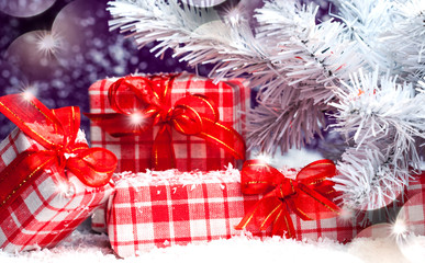 Christmas presents with red bows in the snow