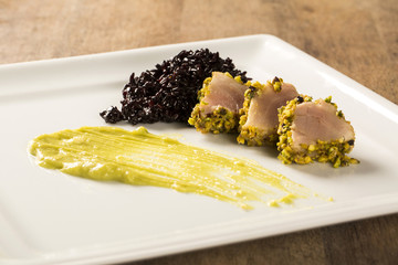 Tuna with pistachio crust, black rice and avocado puree