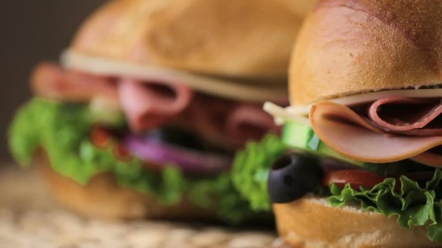 Sub sandwich with fresh vegetables, lunch meat and cheese on hoagie roll