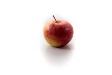 Isolated red apple in a white background casting a shadow