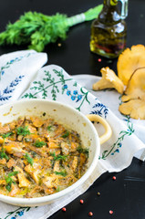 Homemade baked chanterelle mushrooms in frying pan isolated