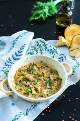 Homemade baked chanterelle mushrooms in frying pan isolated