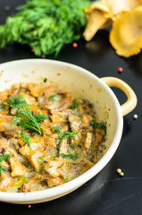 Homemade baked chanterelle mushrooms in frying pan isolated