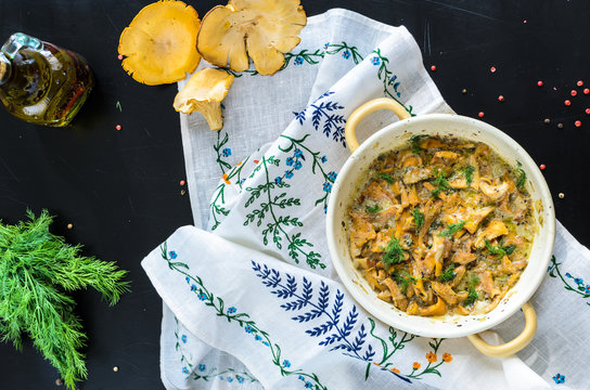 Homemade baked chanterelle mushrooms in frying pan isolated top view
