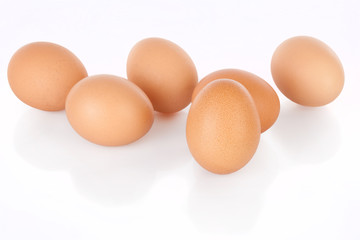Half dozen  brown chicken eggs isolated on white background.