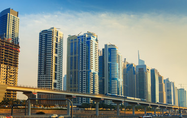 Fototapeta na wymiar Metro line going through Dubai Marina with modern skyscrapers around,Dubai,United Arab Emirates