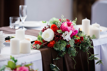 Vintage table decorated with flowers for the wedding ceremony.
