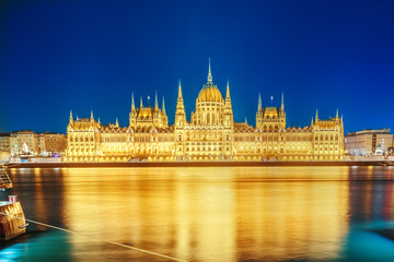 Naklejka premium Budapest Parliament building at night on the Danube river in Hungary. Budapest is capital fo Hungary.