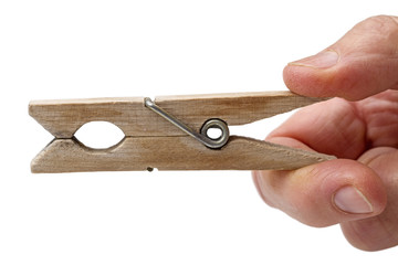 Old wooden clothespin in his hand