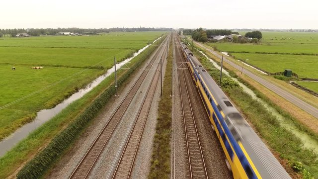 Train passing underneath rising camera, Holland.