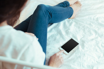 Woman with modern mobile phone in hands