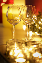 Festive burning candles with wineglasses