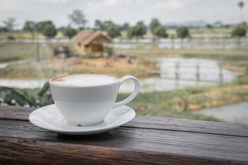 Close up white cup of Coffee, latte on the wooden table