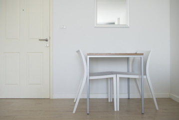 Table beside the door in hotel room.