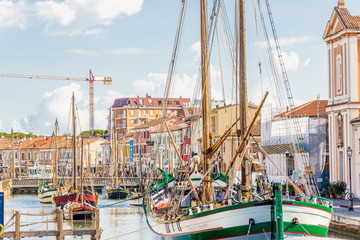 Antique fishing boats in harbor channel