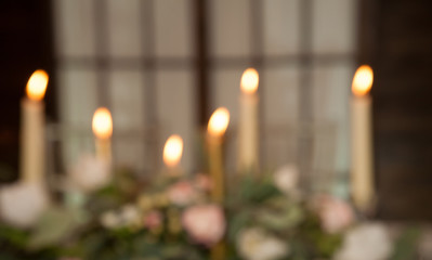 Blurred Christmas Background with burning candle.